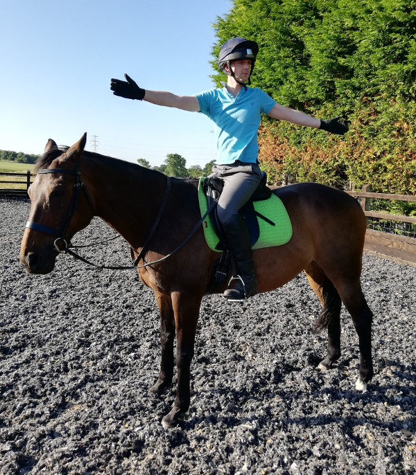 Alex stretching whilst sitting on top of his horse